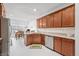 Open kitchen with stainless steel appliances, wood cabinets, granite countertops, and an adjacent dining area at 7236 Sunset Point Dr, Indianapolis, IN 46259