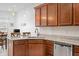 Kitchen featuring granite counters, stainless steel appliances, undermount sink, tile backsplash, and wooden cabinets at 7236 Sunset Point Dr, Indianapolis, IN 46259