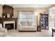 Inviting living room featuring a fireplace, sofa, bookshelf, and a window at 7236 Sunset Point Dr, Indianapolis, IN 46259