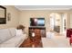 Cozy living room featuring a sofa, television, and an open layout to the foyer at 7236 Sunset Point Dr, Indianapolis, IN 46259