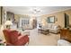 Bright living room featuring a fireplace, sofa, and large windows at 7236 Sunset Point Dr, Indianapolis, IN 46259