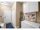 Mud room or entryway with white storage cabinets, a freezer, and a door to the outside at 7236 Sunset Point Dr, Indianapolis, IN 46259