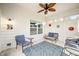 Cozy porch with comfortable blue seating, decorative accents, and a ceiling fan at 7236 Sunset Point Dr, Indianapolis, IN 46259