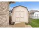 Backyard storage shed with double doors and a decorative horseshoe accent at 7236 Sunset Point Dr, Indianapolis, IN 46259