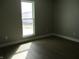 Bedroom with light-filled window and wood-look flooring at 769 E Pearl St, Whiteland, IN 46184