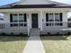 Charming single-story home featuring a covered front porch and freshly landscaped yard at 769 E Pearl St, Whiteland, IN 46184
