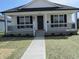 Charming single-story home featuring a covered front porch and freshly landscaped yard at 769 E Pearl St, Whiteland, IN 46184