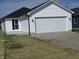 Attached garage with large door and freshly installed gravel driveway at 769 E Pearl St, Whiteland, IN 46184