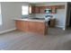 Kitchen features wood cabinets, luxury vinyl plank flooring, and stainless appliances at 769 E Pearl St, Whiteland, IN 46184