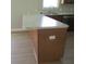 Kitchen island with eat-in countertop space, wood cabinets, and luxury vinyl plank flooring at 769 E Pearl St, Whiteland, IN 46184