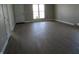Open living room with neutral walls, door to the backyard, and luxury vinyl plank flooring at 769 E Pearl St, Whiteland, IN 46184