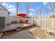 Fenced backyard with deck, landscaping, and mature trees at 7965 Benjamin Dr, Lawrence, IN 46226