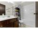 Standard bathroom with a single sink vanity, a decorative shelf, and a shower-tub combination at 7965 Benjamin Dr, Lawrence, IN 46226