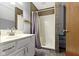 Cozy bathroom featuring a shower with tile surround and white vanity at 7965 Benjamin Dr, Lawrence, IN 46226
