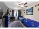 Cozy bedroom decorated with sports themes, featuring blue bedding and a ceiling fan with lighting at 7965 Benjamin Dr, Lawrence, IN 46226