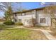 Charming townhouse featuring a well-maintained lawn, a front door wreath, and neutral-toned siding at 7965 Benjamin Dr, Lawrence, IN 46226