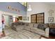 Open-concept living area with a large sectional sofa and views into the kitchen and to the upper level at 7965 Benjamin Dr, Lawrence, IN 46226