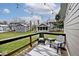 View of the backyard featuring a wooden deck with seating and overhead string lights at 8077 Foxchase Dr, Indianapolis, IN 46256