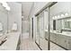 A view of the bathroom featuring a double vanity and a shower at 8077 Foxchase Dr, Indianapolis, IN 46256
