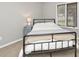 Cozy bedroom featuring a metal frame bed, neutral walls, and natural light at 8077 Foxchase Dr, Indianapolis, IN 46256