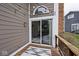 Wooden deck with sliding glass door, string lights, and exterior siding at 8077 Foxchase Dr, Indianapolis, IN 46256