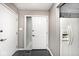 Bright foyer featuring tiled floors, a closet, and a view of the kitchen appliances at 8077 Foxchase Dr, Indianapolis, IN 46256