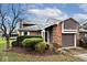 Inviting home showcasing a blend of brick, vinyl siding, an attached garage, and manicured landscaping at 8077 Foxchase Dr, Indianapolis, IN 46256