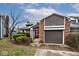 Charming home with a brick and vinyl exterior, featuring an attached garage and manicured landscaping at 8077 Foxchase Dr, Indianapolis, IN 46256