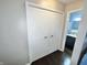 Hallway featuring a view of a bathroom and a white double-door closet at 8077 Foxchase Dr, Indianapolis, IN 46256