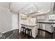 A view of the kitchen with a breakfast bar and granite countertops at 8077 Foxchase Dr, Indianapolis, IN 46256