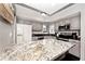 Spacious kitchen with a large granite island, stainless steel appliances, and ample cabinet space at 8077 Foxchase Dr, Indianapolis, IN 46256