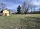 Large backyard featuring a shed, mature trees, and well-maintained lawn providing ample space for storage at 839 S Paddock Rd, Greenwood, IN 46143