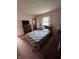 Cozy bedroom featuring a colorful quilt, wood dresser, and natural light from the window at 839 S Paddock Rd, Greenwood, IN 46143