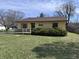 Charming single-story home featuring a handicap-accessible ramp, well-maintained lawn, and mature landscaping at 839 S Paddock Rd, Greenwood, IN 46143