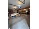 Large three car garage with concrete floors, overhead lighting, and plenty of shelving at 839 S Paddock Rd, Greenwood, IN 46143