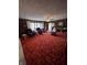 Comfortable living room with wood-paneled walls, plush carpeting, and a bright bay window at 839 S Paddock Rd, Greenwood, IN 46143