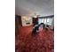 Spacious living room with a brick fireplace, plush carpeting, and a bright bay window at 839 S Paddock Rd, Greenwood, IN 46143