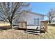 Backyard featuring a wooden deck and a large tree, offering a great space for outdoor relaxation at 888 Streamside Dr, Greenfield, IN 46140