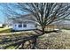 Backyard featuring a wooden deck and a large tree, offering a great space for outdoor relaxation at 888 Streamside Dr, Greenfield, IN 46140