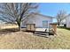 Backyard wooden deck perfect for outdoor entertaining with a tree at 888 Streamside Dr, Greenfield, IN 46140