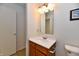 Bathroom with vanity, mirror, lighting, and toilet at 888 Streamside Dr, Greenfield, IN 46140
