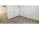 Bedroom view with carpet flooring, ceiling fan visible in the adjacent room, and a closet at 888 Streamside Dr, Greenfield, IN 46140