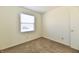 Bright bedroom featuring neutral carpet, a window with blinds, and minimalist decor at 888 Streamside Dr, Greenfield, IN 46140