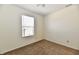 Bright bedroom featuring neutral carpet and white walls, complemented by a window at 888 Streamside Dr, Greenfield, IN 46140