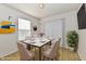 Light-filled dining room features a modern table set for six, artwork, and stylish chairs at 888 Streamside Dr, Greenfield, IN 46140