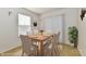 Cozy dining room features a wood table, six chairs and decorative butterfly art at 888 Streamside Dr, Greenfield, IN 46140