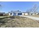 Inviting one-story home with blue shutters and attached garage at 888 Streamside Dr, Greenfield, IN 46140