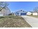One-story home with blue shutters and a long driveway at 888 Streamside Dr, Greenfield, IN 46140