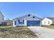 Charming house with blue garage door and well-maintained front yard at 888 Streamside Dr, Greenfield, IN 46140