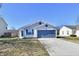 Charming single-story home with a well-maintained lawn and a two-car garage at 888 Streamside Dr, Greenfield, IN 46140